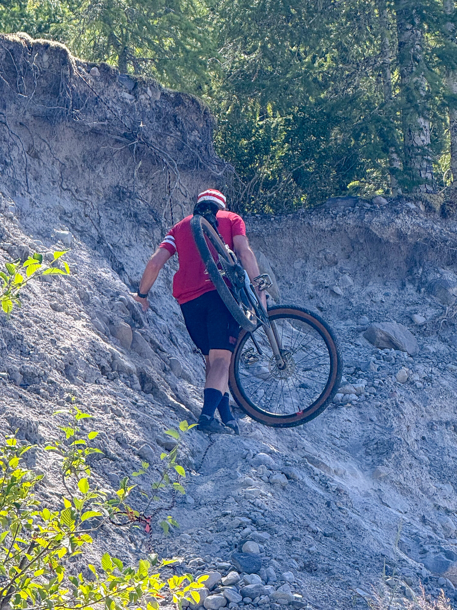 Amy riding down a steep wall of grey pumice
